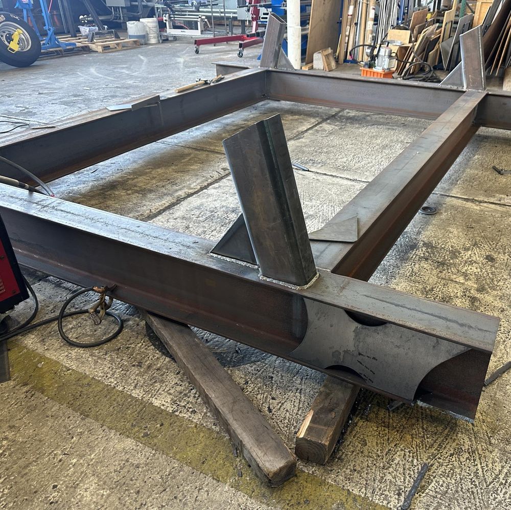 Stand frame welded up — boxed where torsional rigidity mattered, gusseted at the caster posts.