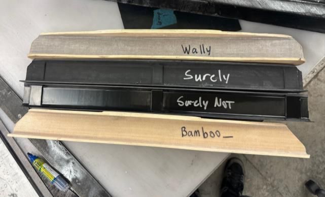 Four submissions. Two carbon, two natural-fiber — the bamboo and spruce build is the pale one.